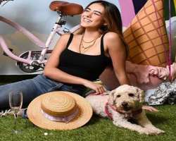 She has a cute adorable dog in her home She has a cute adorable dog in her home.